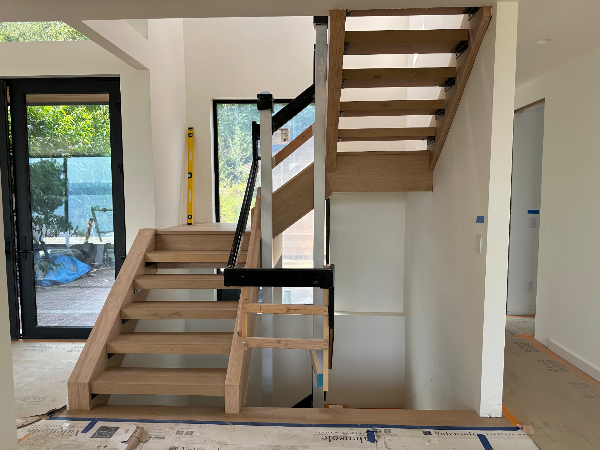 Unfinished white oak block treads on a switchback floating staircase in a lakefront Bellevue, Washington home.