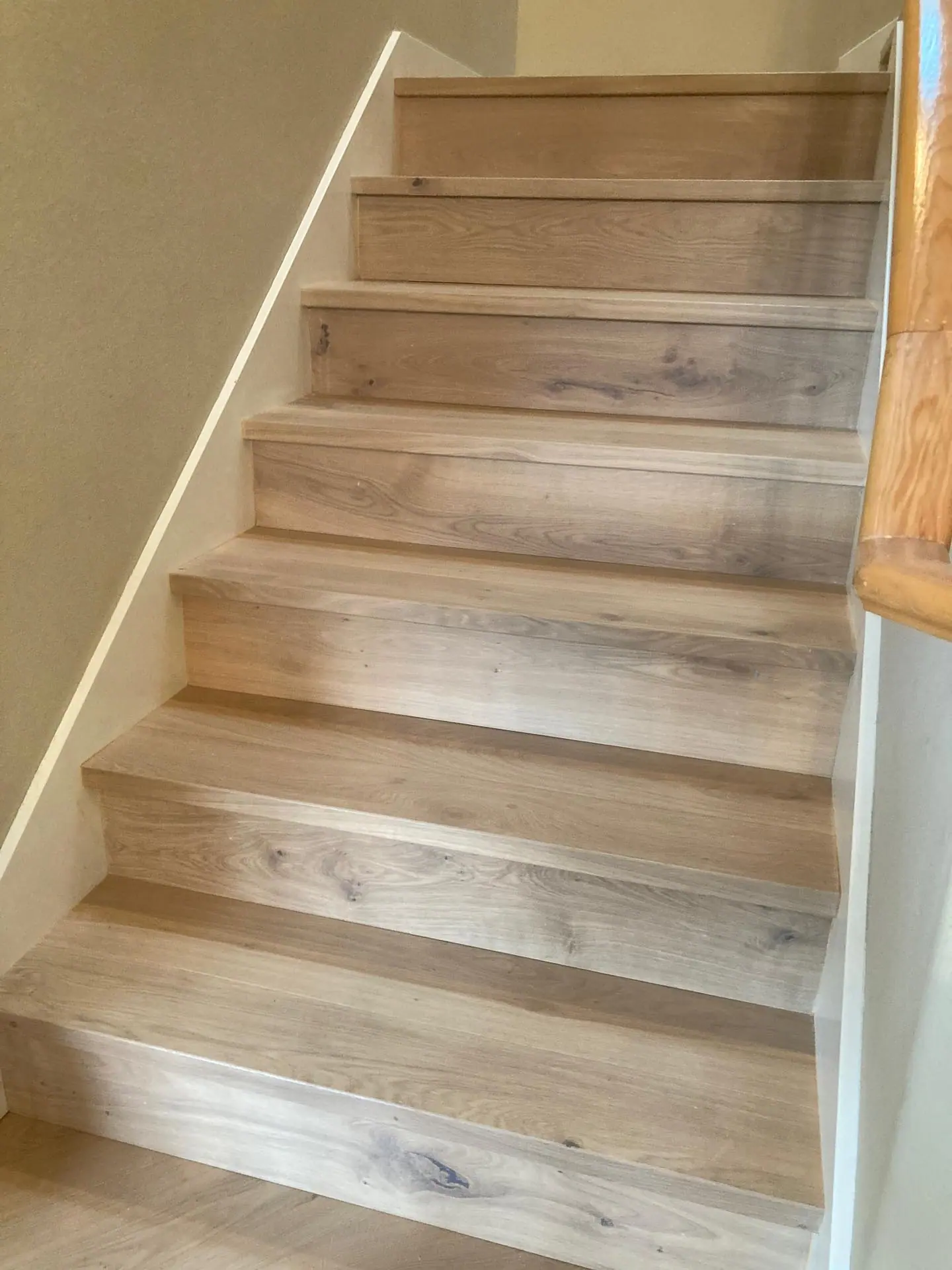 Flush stair nosing matched to engineered oak flooring on a staircase in Seattle, Washington.
