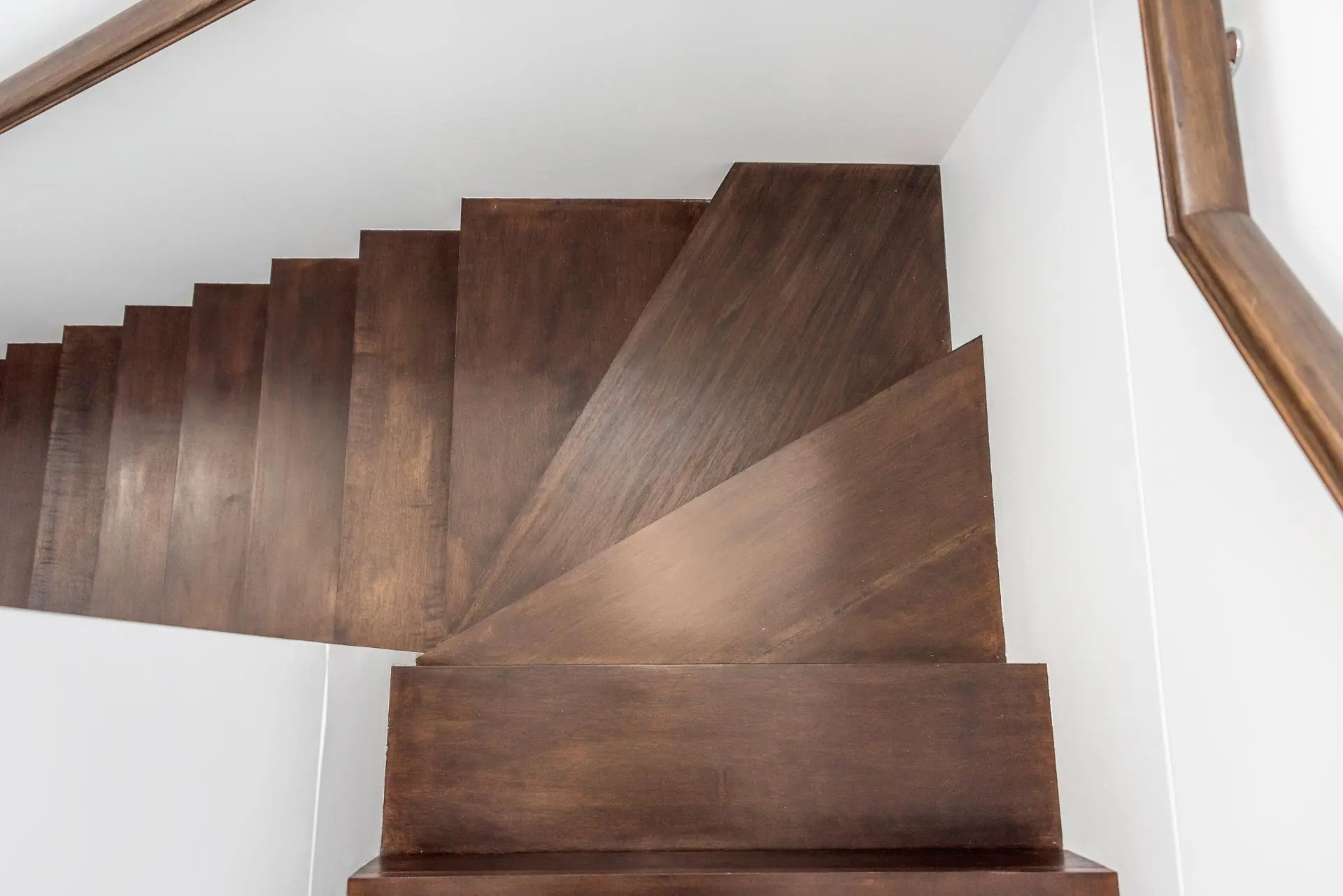 Waterfall stair nosing fabricated from luxury vinyl plank on a finished staircase in Tacoma, Washington.