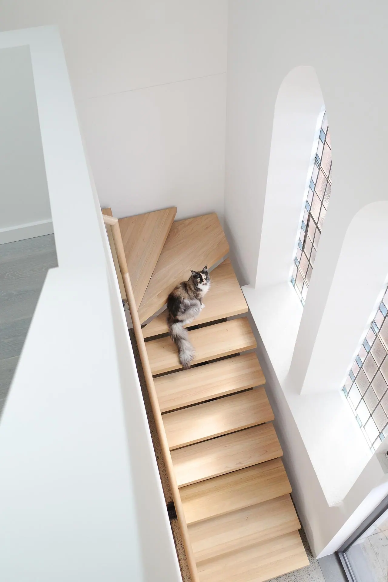 Open riser staircase with custom laminated block treads in Tukwila, Washington.