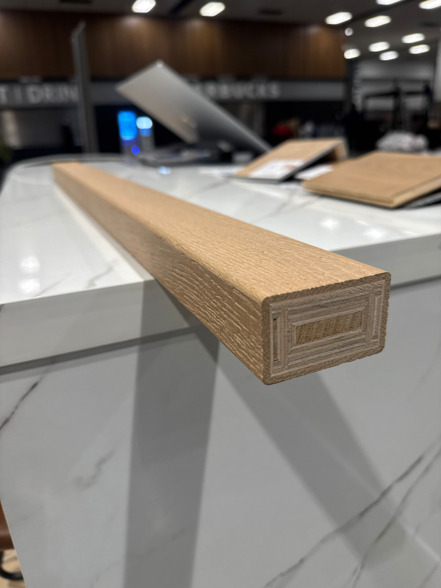 Machined square-profile white oak handrail blank showing the routed end grain detail at the Voda Stairs shop in Tukwila, Washington.