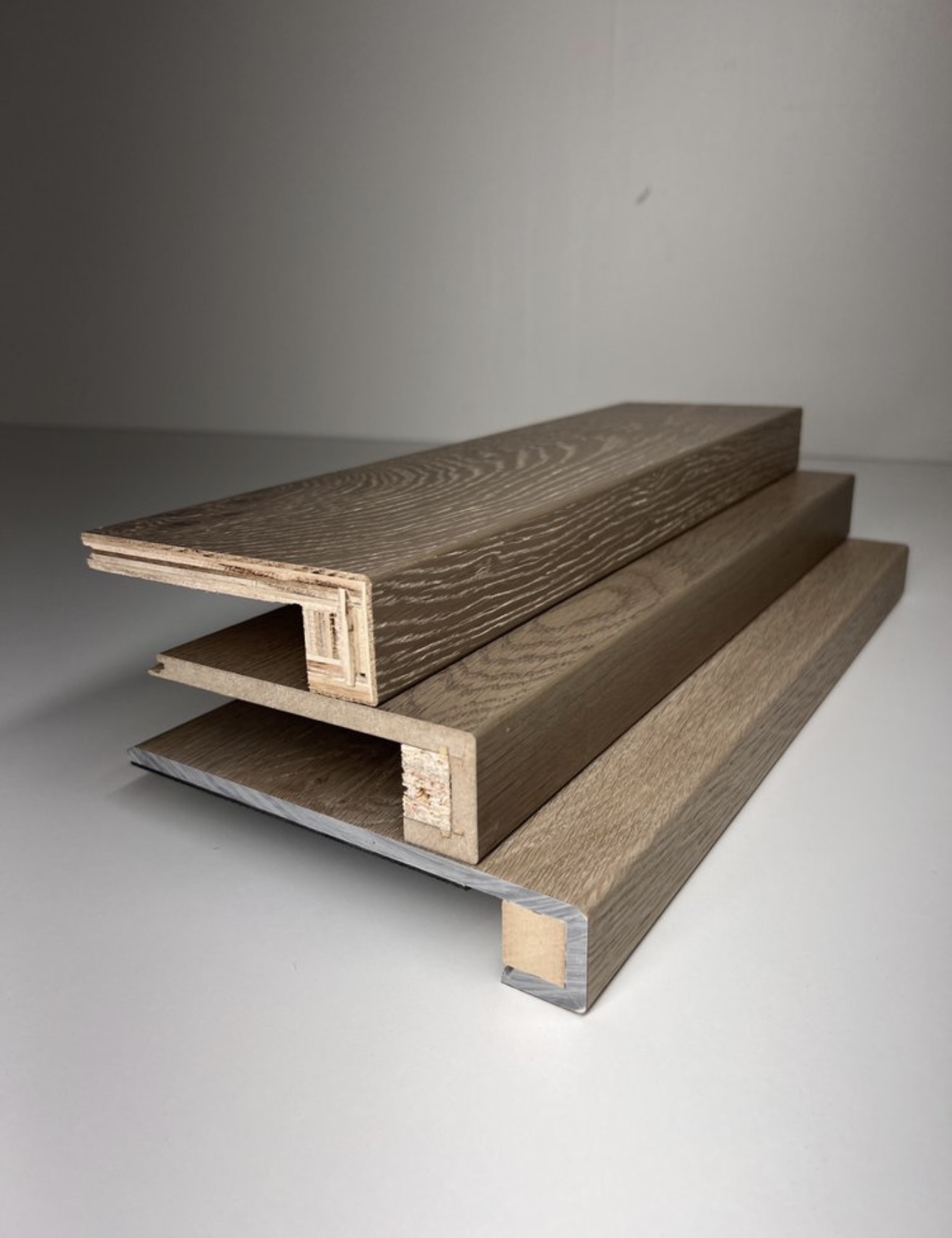 Three custom stair nose profiles stacked to show the female lock, overlap and square nose construction milled from customer flooring